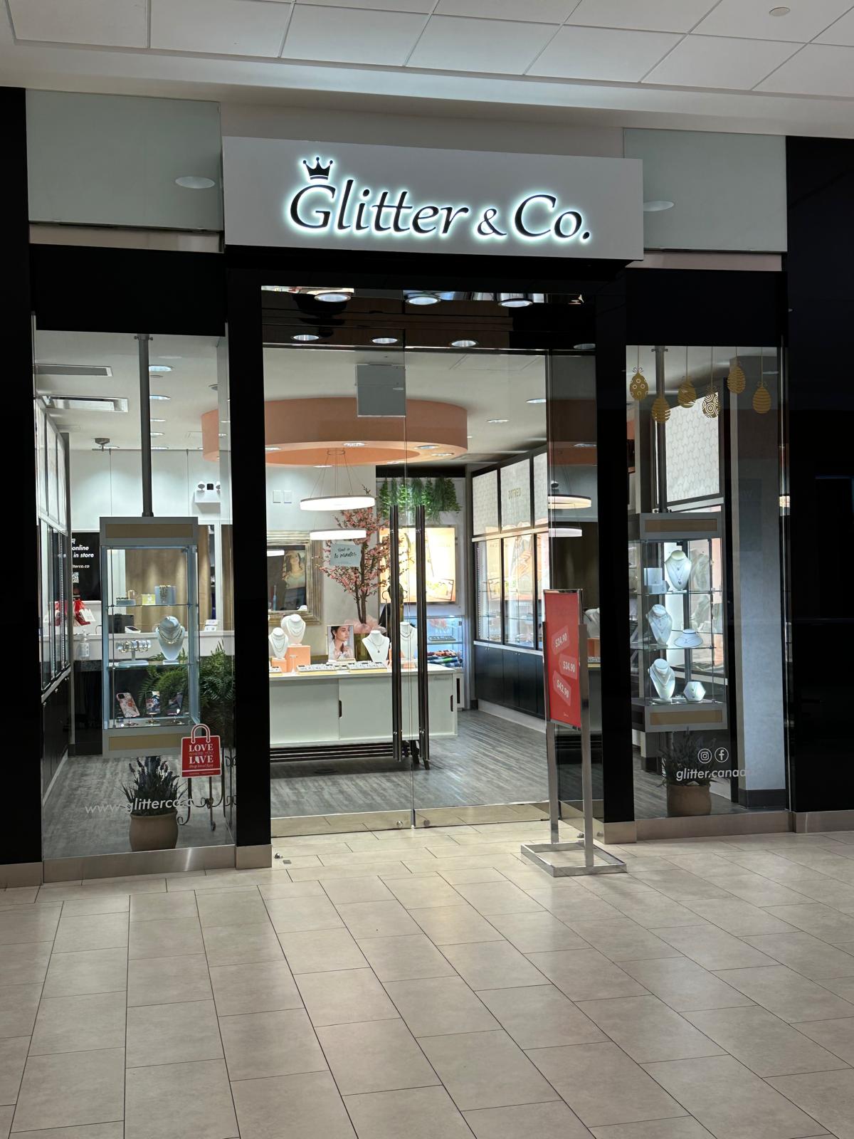 Glitter & Co. halo-lit storefront sign inside a mall