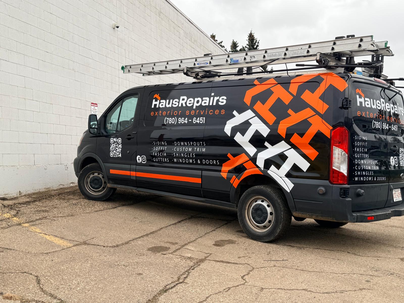 HausRepairs orange and black van wrap, side view