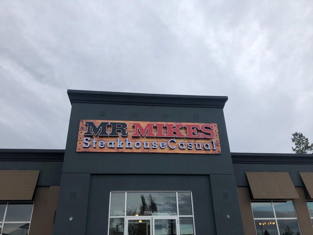 Mr Mikes Steakhouse Casual illuminated channel letter sign on a storefront