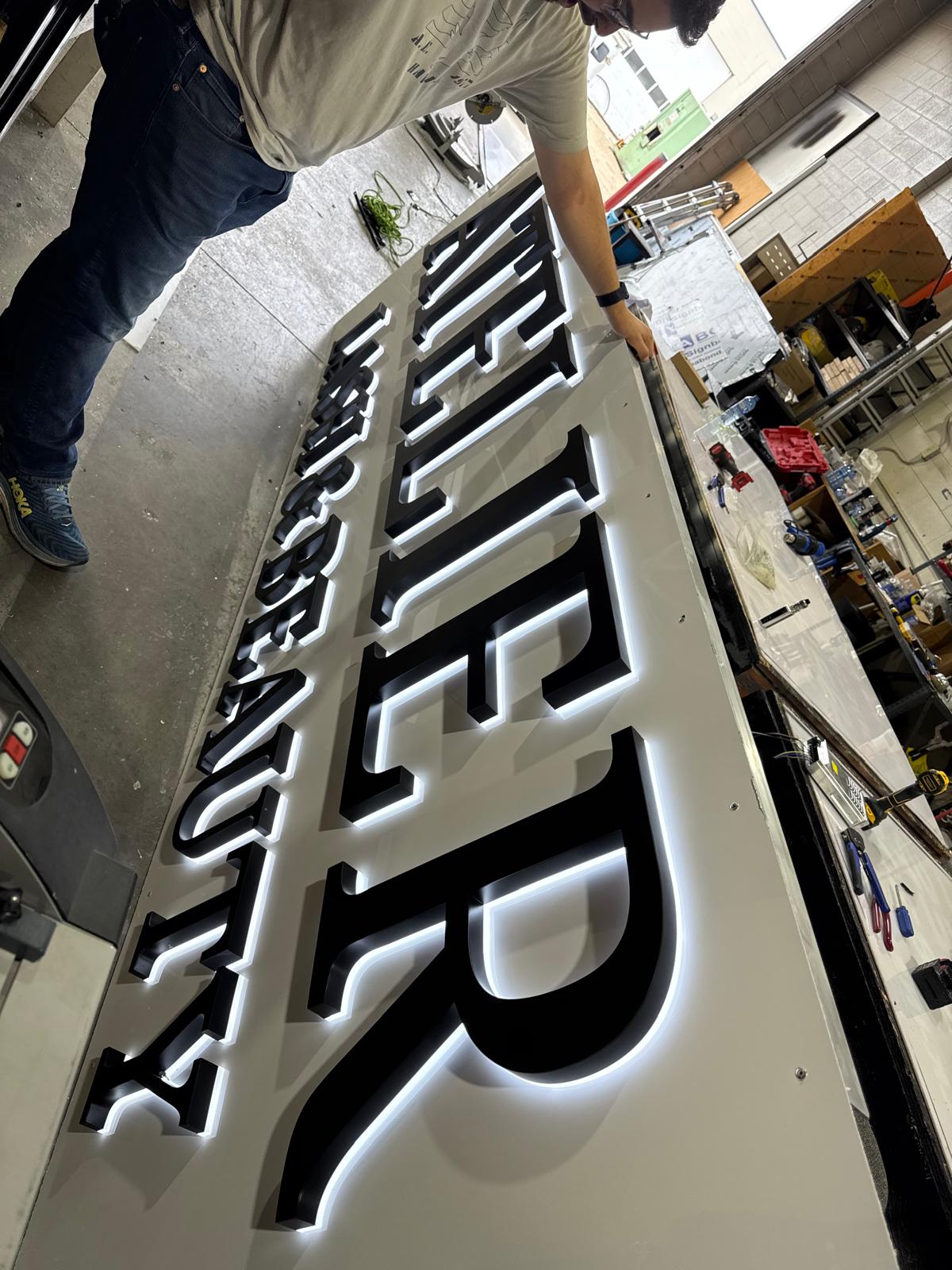 Backlit halo channel letters being built in the Davis Printing shop