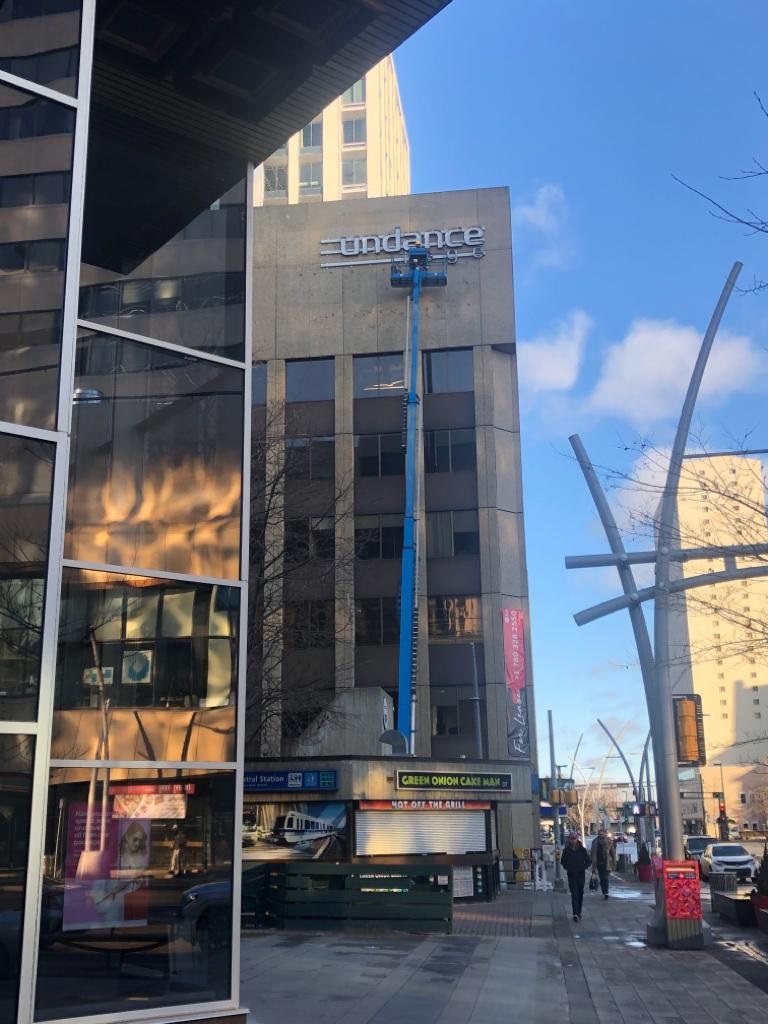 Rooftop illuminated sign installation in downtown Edmonton